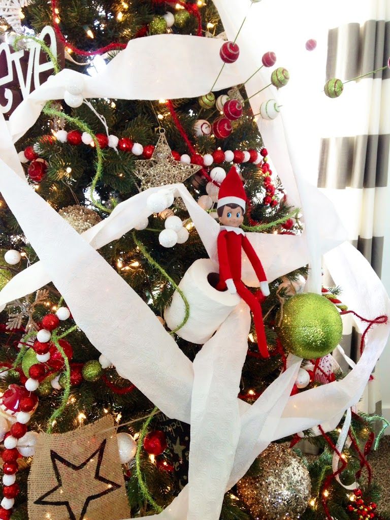 Nestašni vilenjak na polici slike s toaletnim papirom na božićnom drvcu