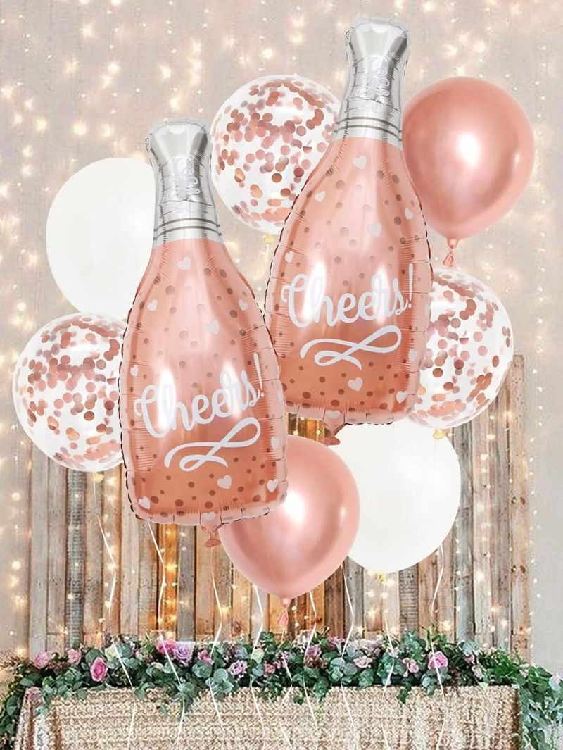Ballons de graduation roses avec bouteille de champagne