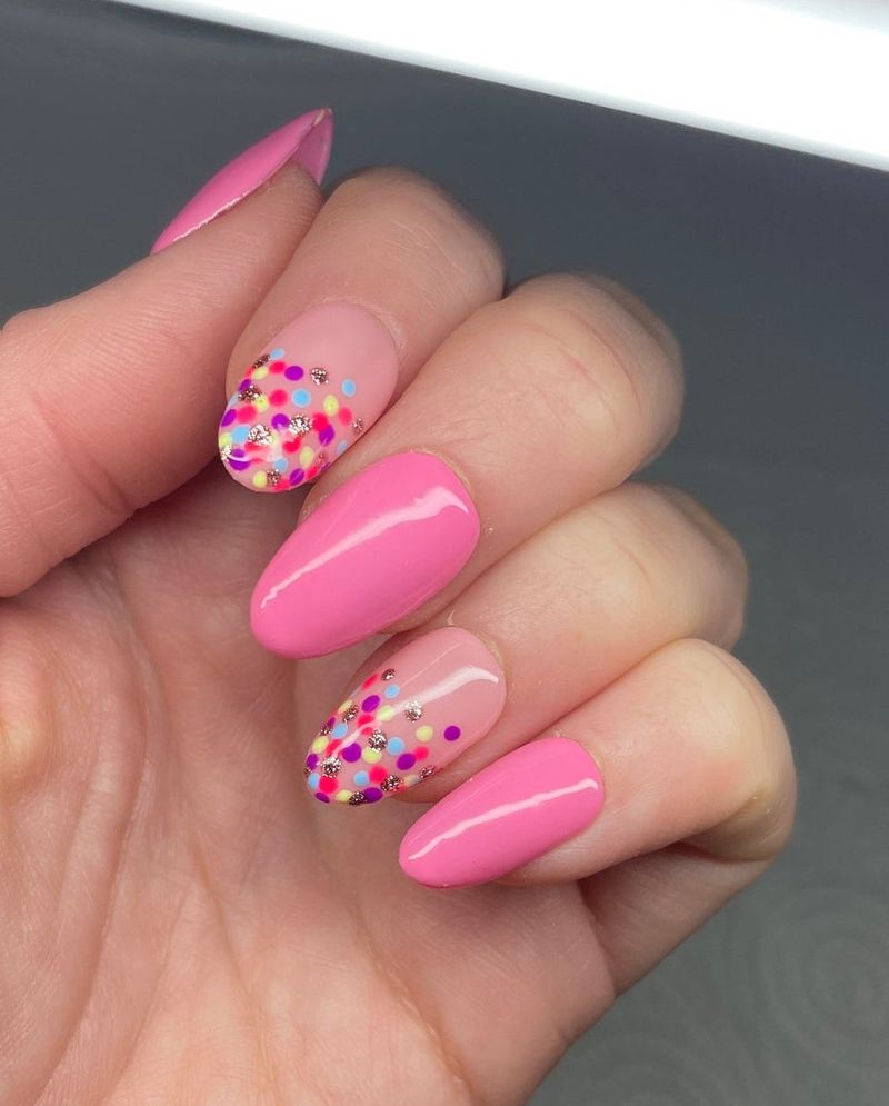 Милі яскраво-рожеві нігті з барвистими горошок